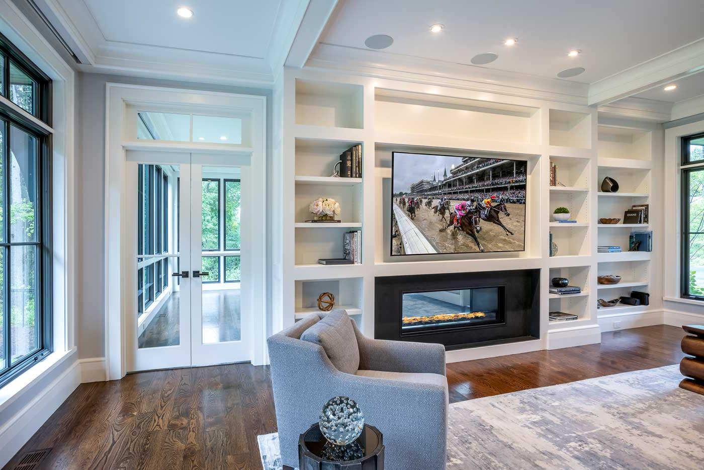 Shingle style home in rural wooded setting - room with built-in cabinets designed by Curl Simitis Architecture + Design